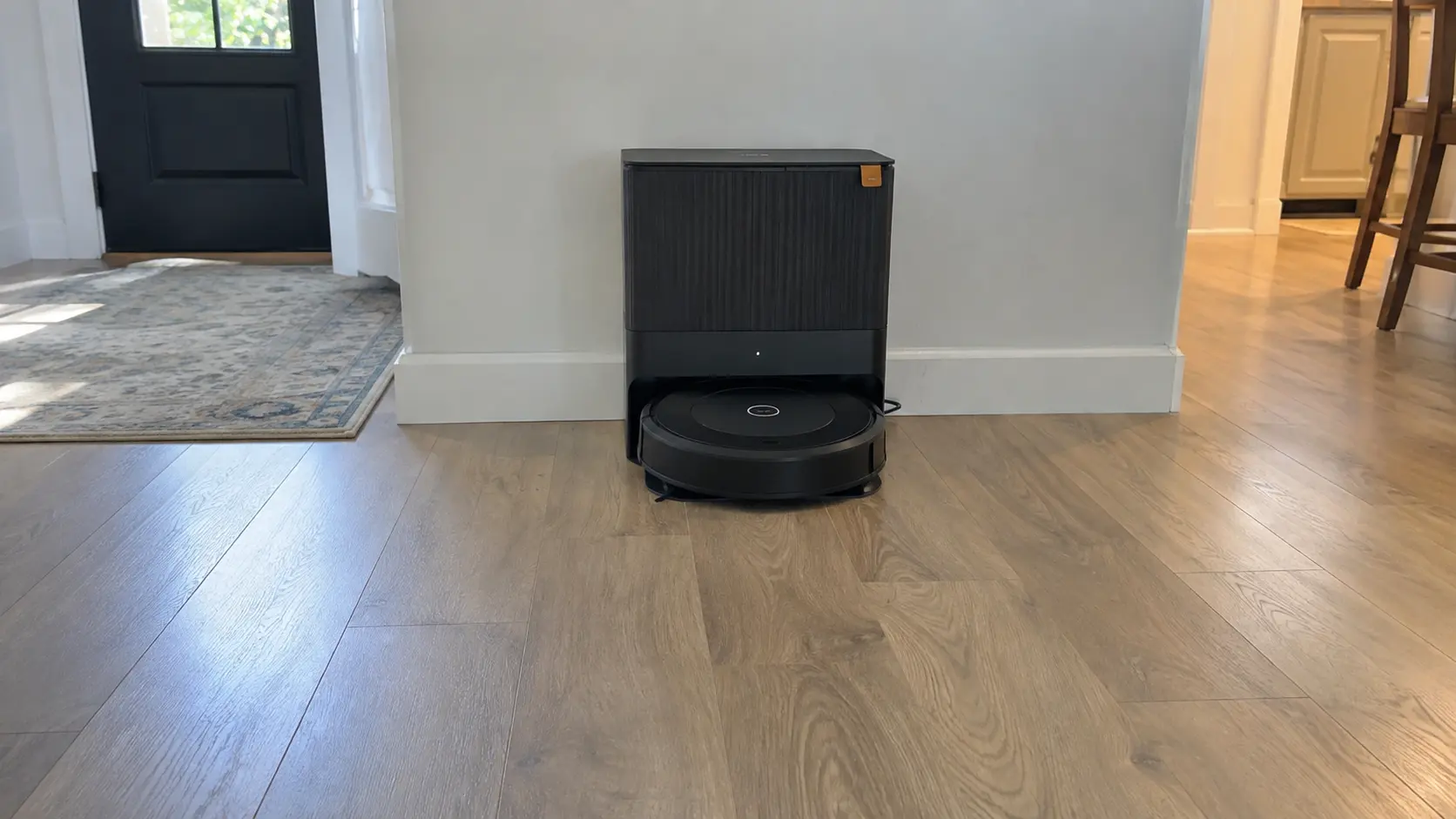 Robot vacuum charging dock positioned correctly against a wall.
