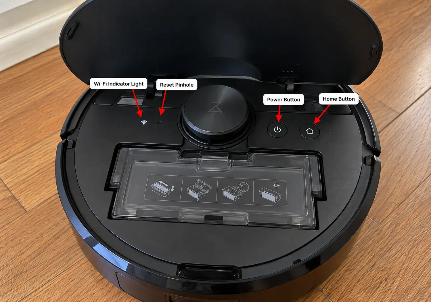 robot vacuum with top cover open showing the Wi-Fi light and reset pinhole.